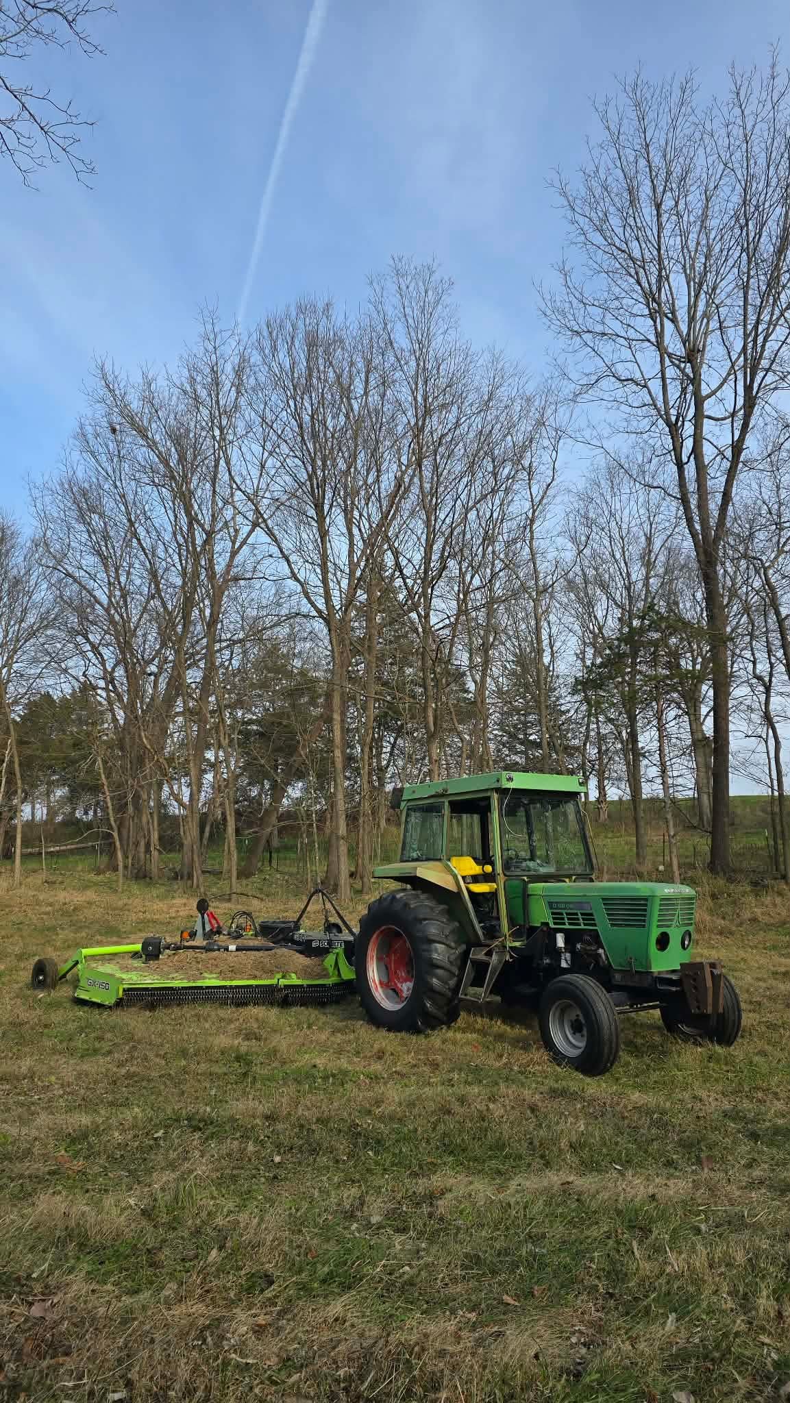 Front view of Lance's green tractor with enclosed cab